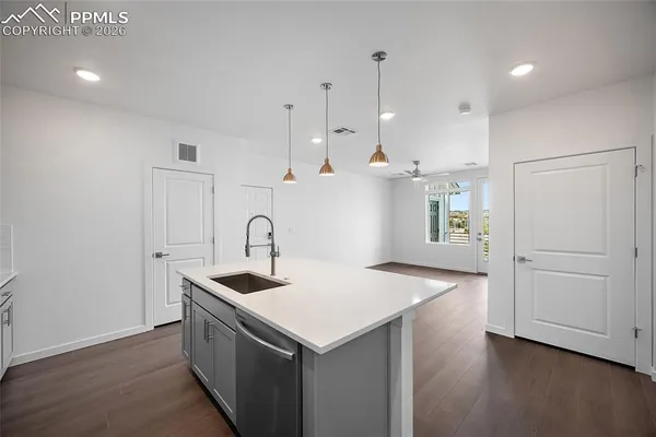 a kitchen that has a sink a stove and a refrigerator