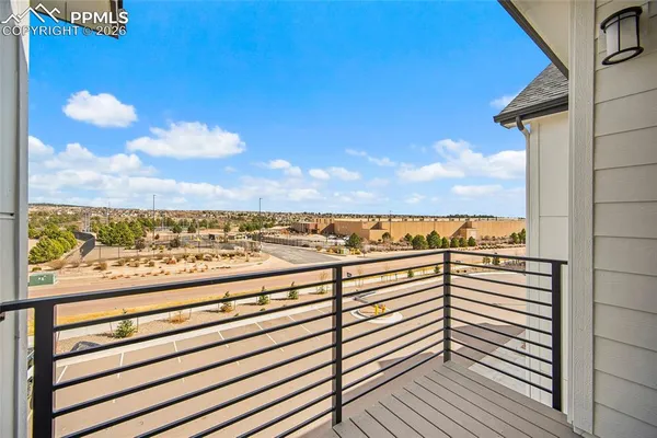 a view of a balcony with wooden floor and city view