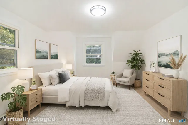 a bedroom with a bed and a couch