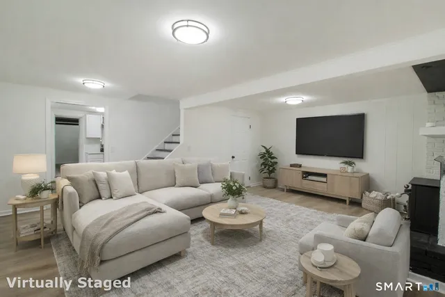a living room with furniture and a flat screen tv