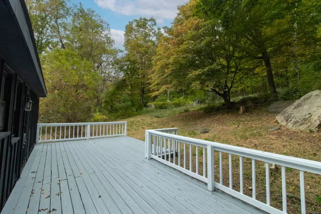 a balcony with wooden floor and fence