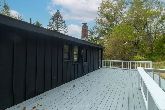 a balcony with wooden floor in front of it