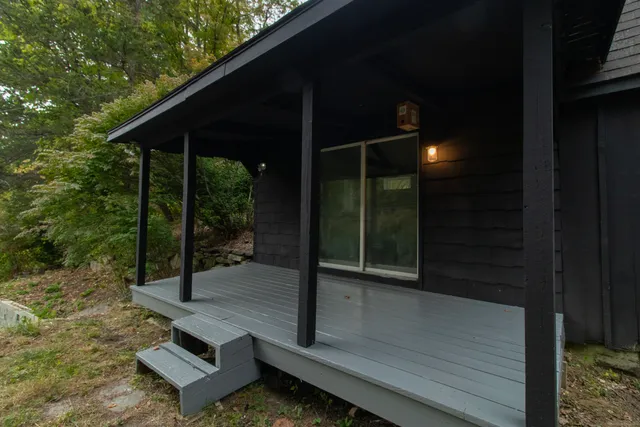 a backyard of a house with table and chairs