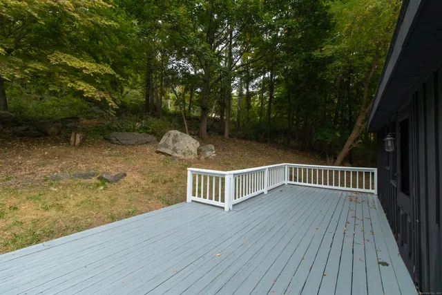 a view of balcony with wooden floor and fence