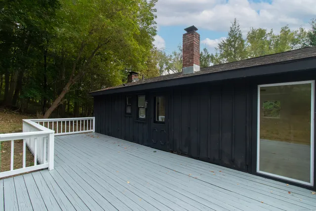 a view of a house with a wooden fence