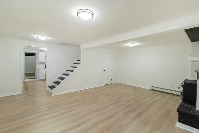 a view of an empty room with wooden floor
