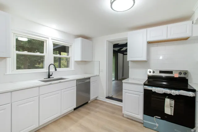 a kitchen with a sink and a stove