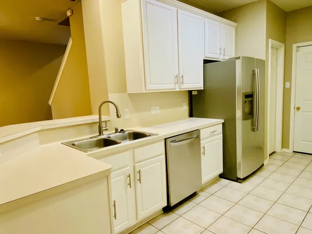 a kitchen with a sink and refrigerator