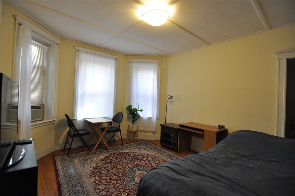 131 Park Drive, Unit 11 Boston, MA 02215 - Photo 1 of 15 a bed room with a bed and furniture