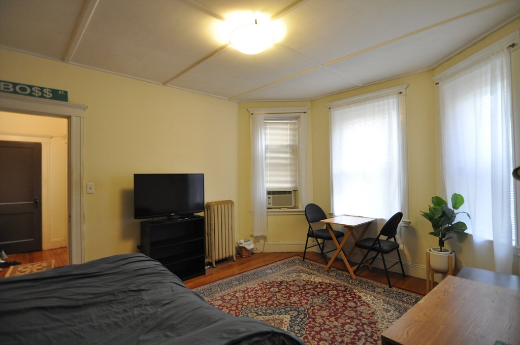 131 Park Drive, Unit 11 Boston, MA 02215 - Photo 2 of 15 a living room with furniture and a flat screen tv