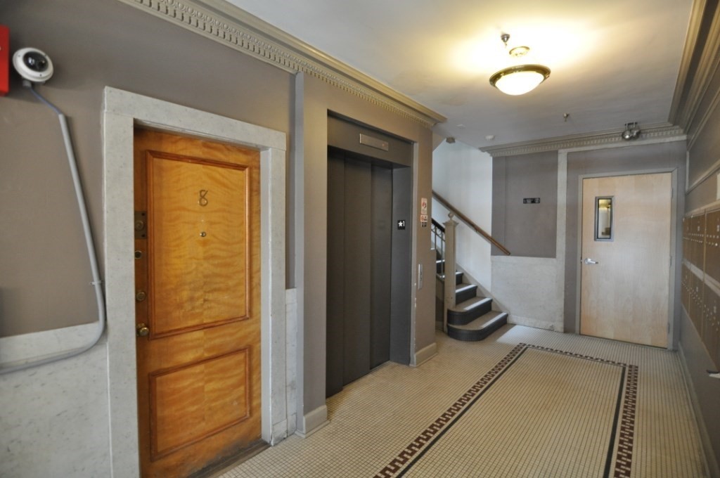 131 Park Drive, Unit 11 Boston, MA 02215 - Photo 9 of 15 a view of a hallway with a livingroom and stairs