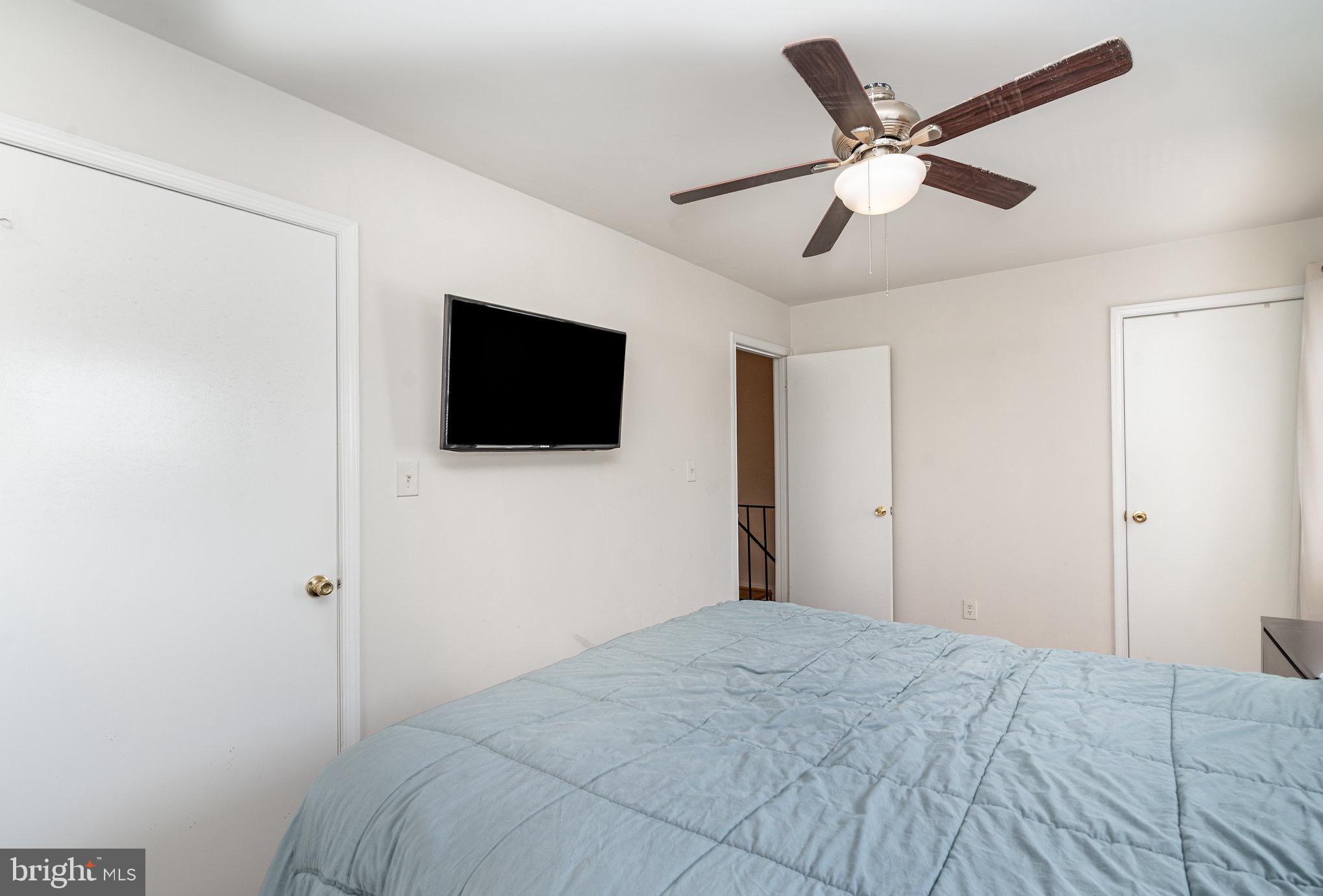 205 Powhatan Court, Unit 100 Stafford, VA 22556 - Photo 11 of 23 a bedroom with a large bed and a flat screen tv
