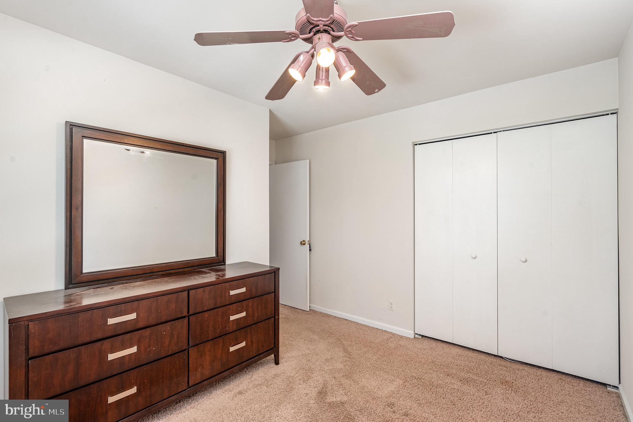 205 Powhatan Court, Unit 100 Stafford, VA 22556 - Photo 13 of 23 a room with a dresser and a flat screen tv