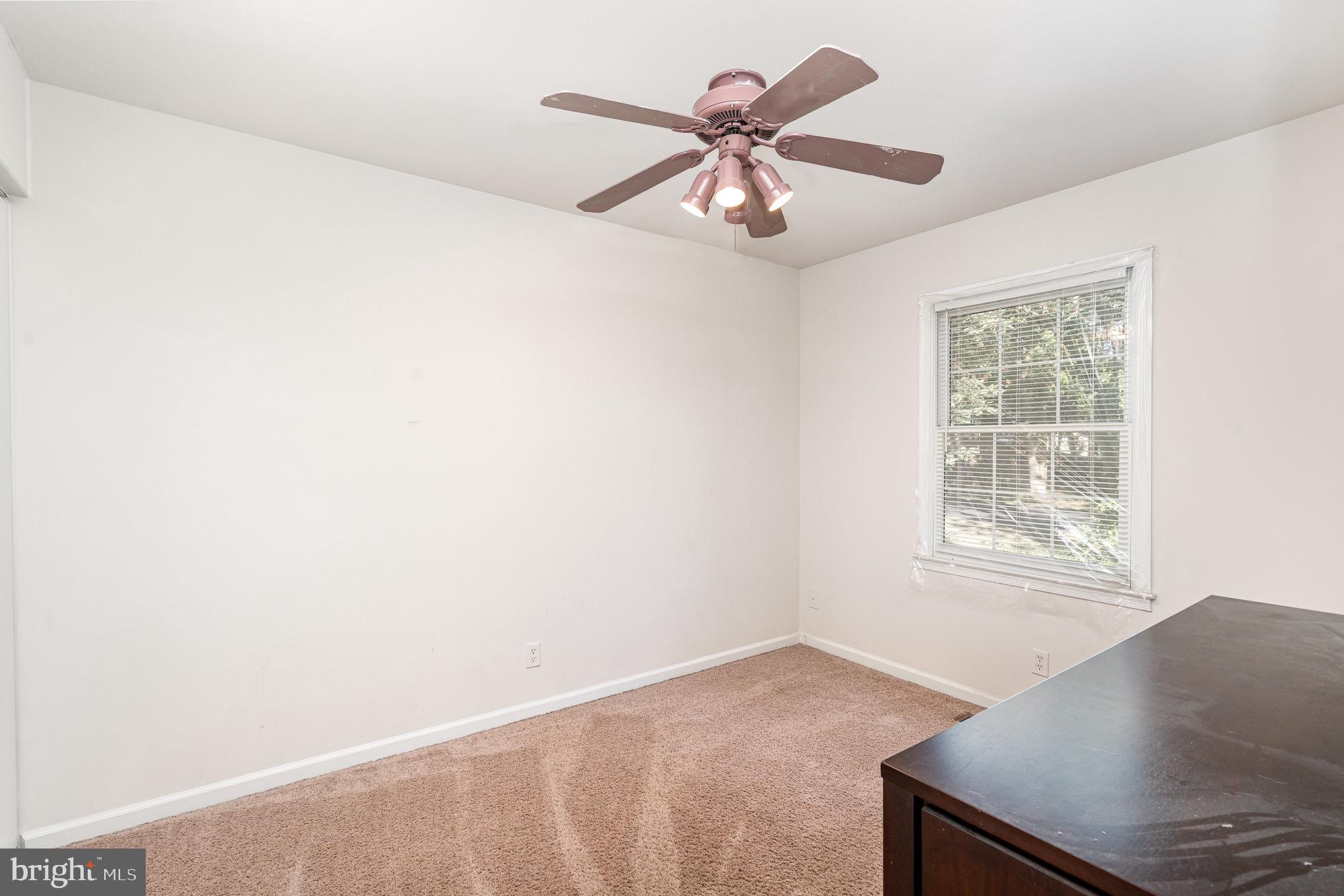 205 Powhatan Court, Unit 100 Stafford, VA 22556 - Photo 14 of 23 an empty room with windows and fan