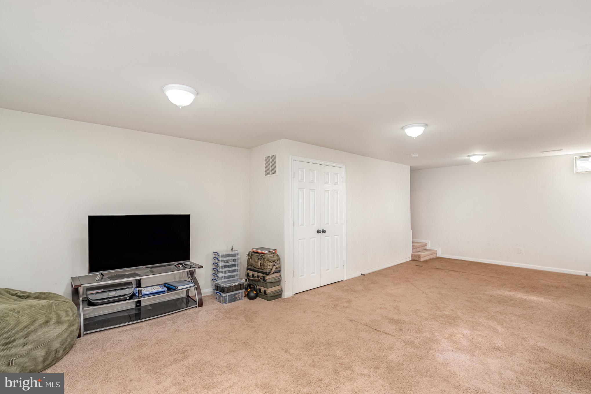 205 Powhatan Court, Unit 100 Stafford, VA 22556 - Photo 17 of 23 a living room with furniture and a flat screen tv
