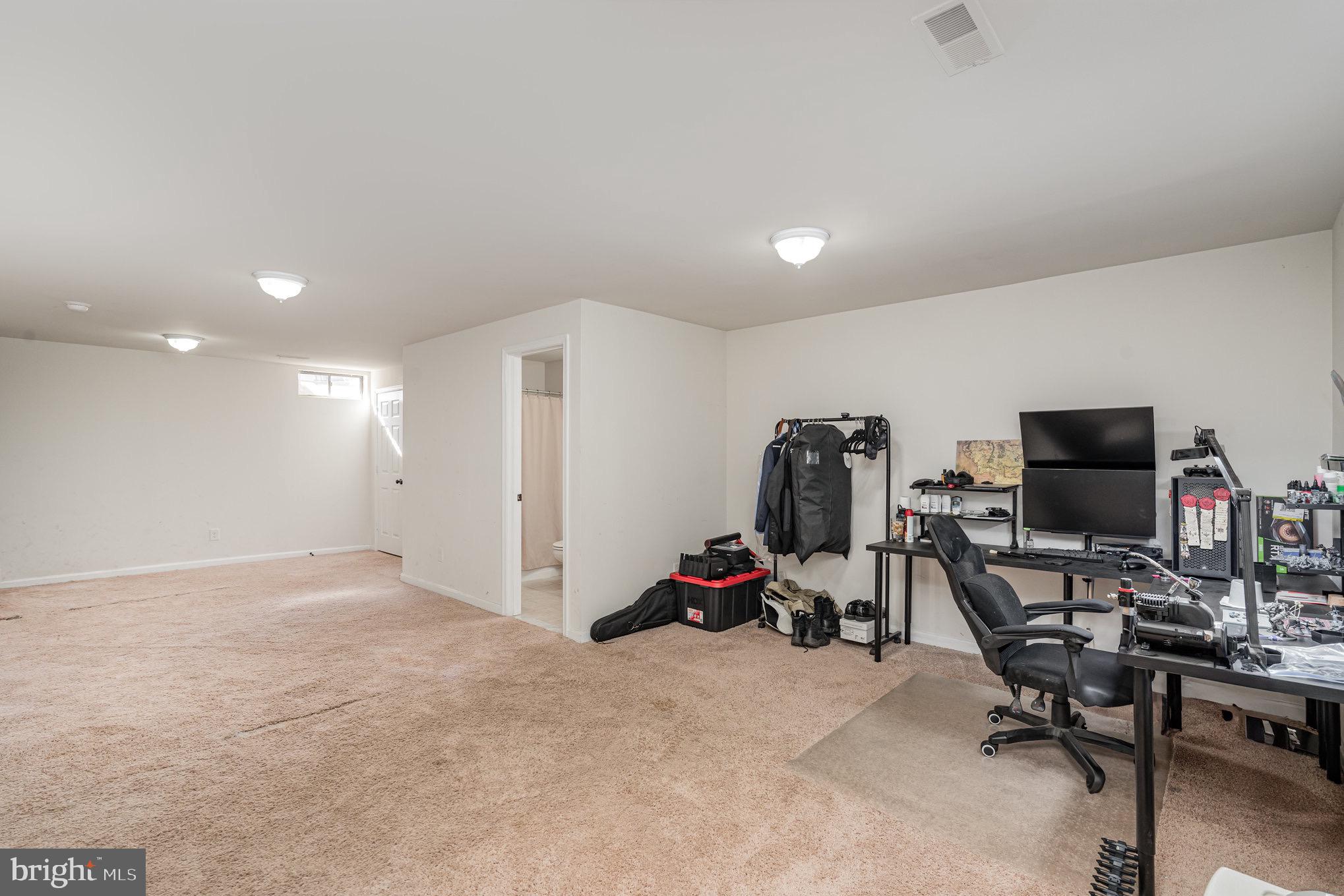 205 Powhatan Court, Unit 100 Stafford, VA 22556 - Photo 19 of 23 a view of a workspace with furniture and a window