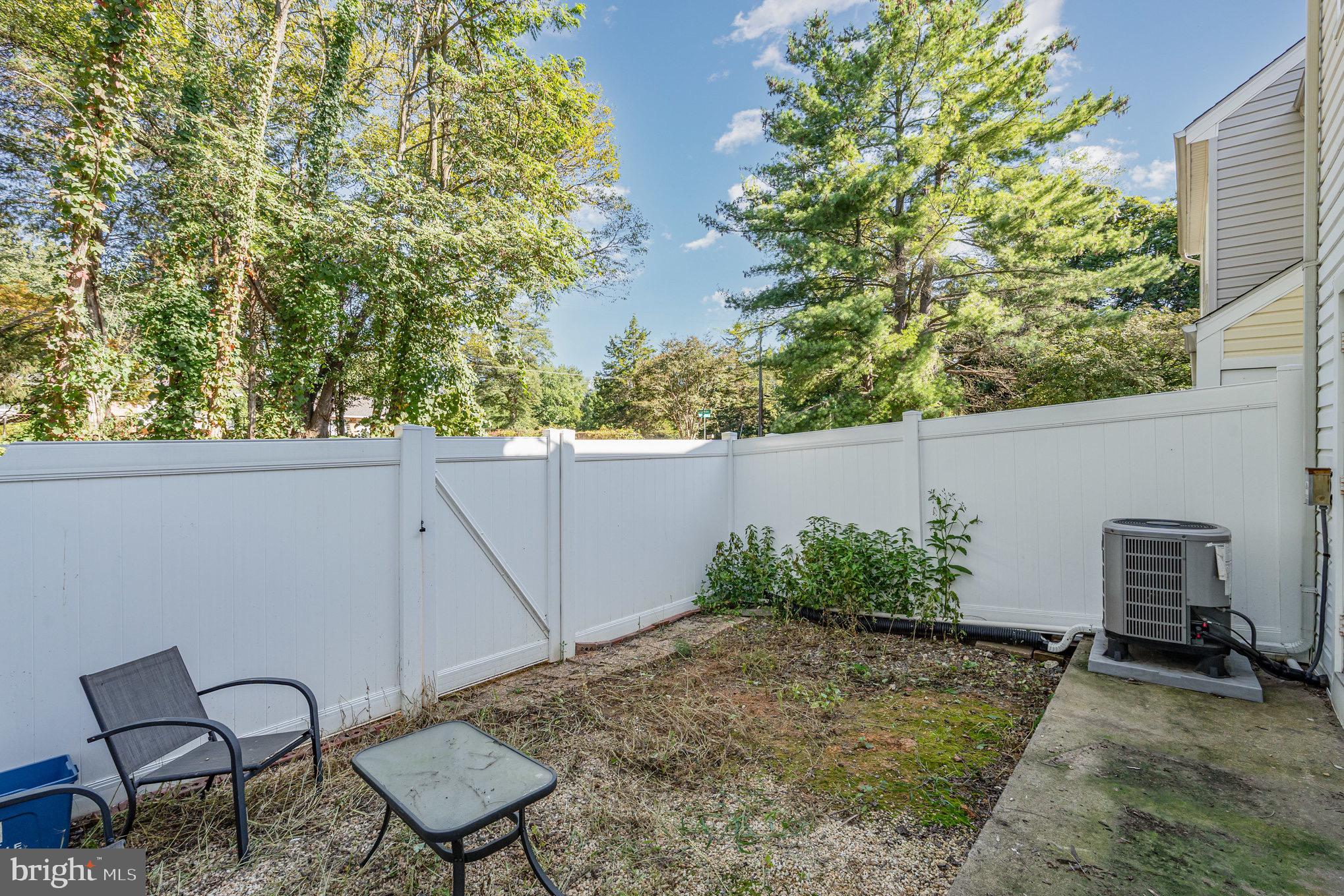 205 Powhatan Court, Unit 100 Stafford, VA 22556 - Photo 23 of 23 a backyard of a house with table and chairs
