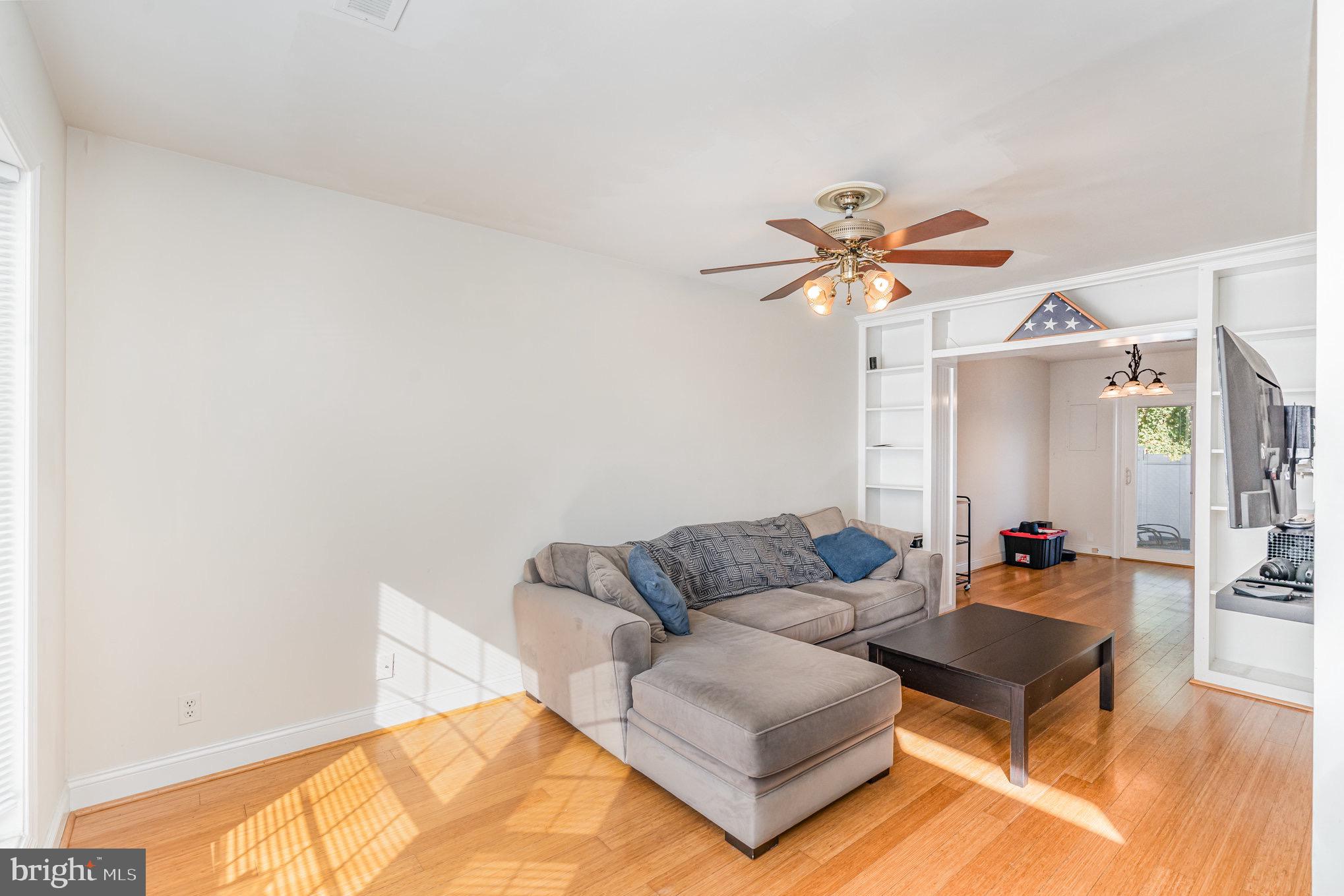 205 Powhatan Court, Unit 100 Stafford, VA 22556 - Photo 3 of 23 a living room with furniture and a chandelier