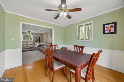 a view of a dining room with furniture and a chandelier