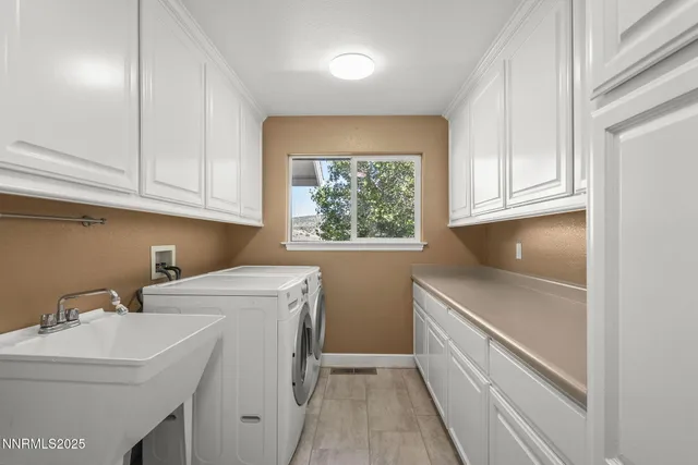 a utility room with sink dryer and washer