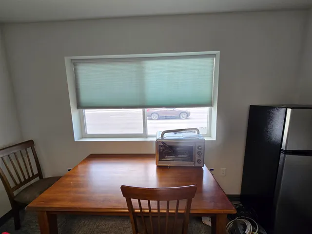 a view of a room with wooden floor and windows