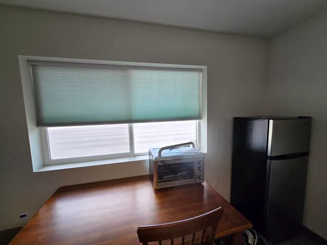 a living room with stainless steel appliances kitchen island granite countertop furniture and a view of kitchen