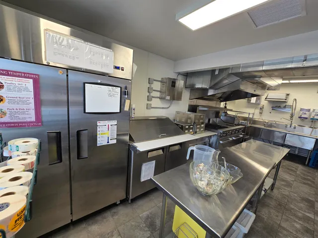 a kitchen with stainless steel appliances kitchen island granite countertop a sink and cabinets