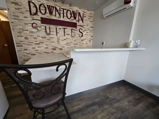 a large kitchen with stainless steel appliances a large counter top and a refrigerator