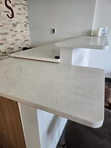 a kitchen with stainless steel appliances kitchen island granite countertop a refrigerator and a stove