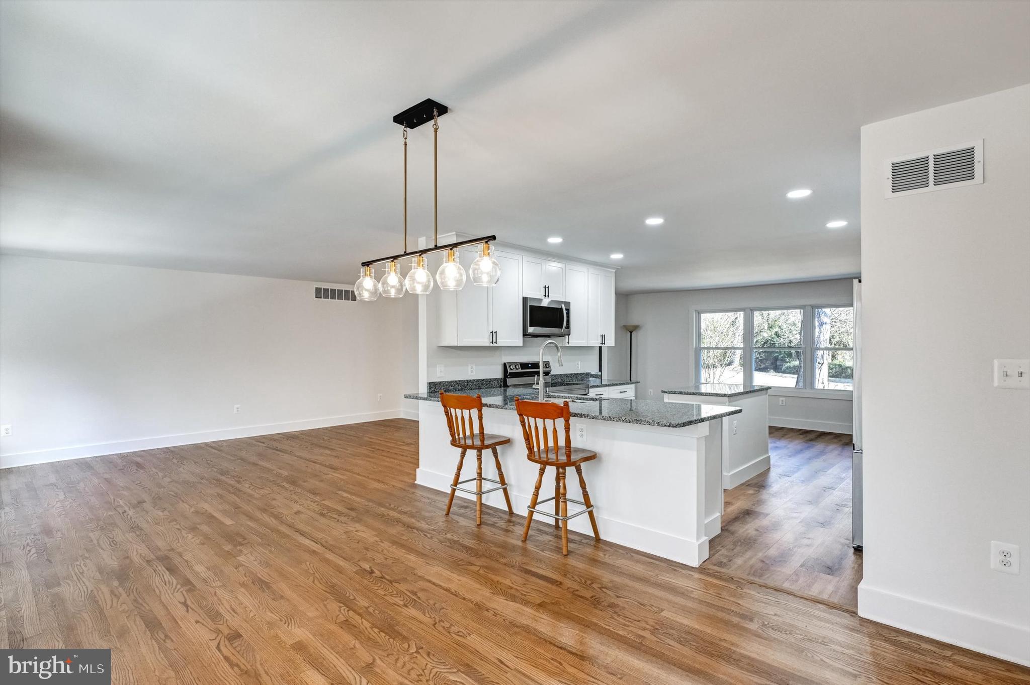 2806 Foxhound Road Ellicott City, MD 21042 - Photo 11 of 55 a view of a dining room with furniture window and wooden floor