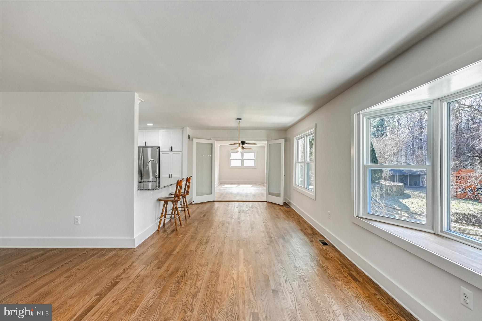 2806 Foxhound Road Ellicott City, MD 21042 - Photo 16 of 55 a view of empty room with wooden floor and fan