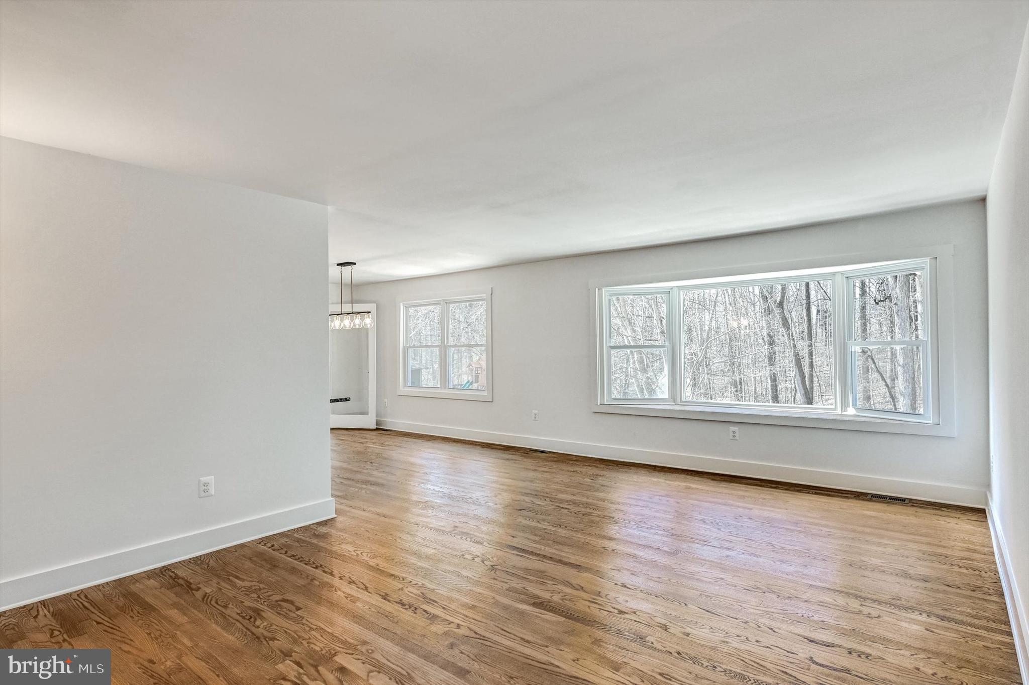 2806 Foxhound Road Ellicott City, MD 21042 - Photo 17 of 55 an empty room with wooden floor and windows