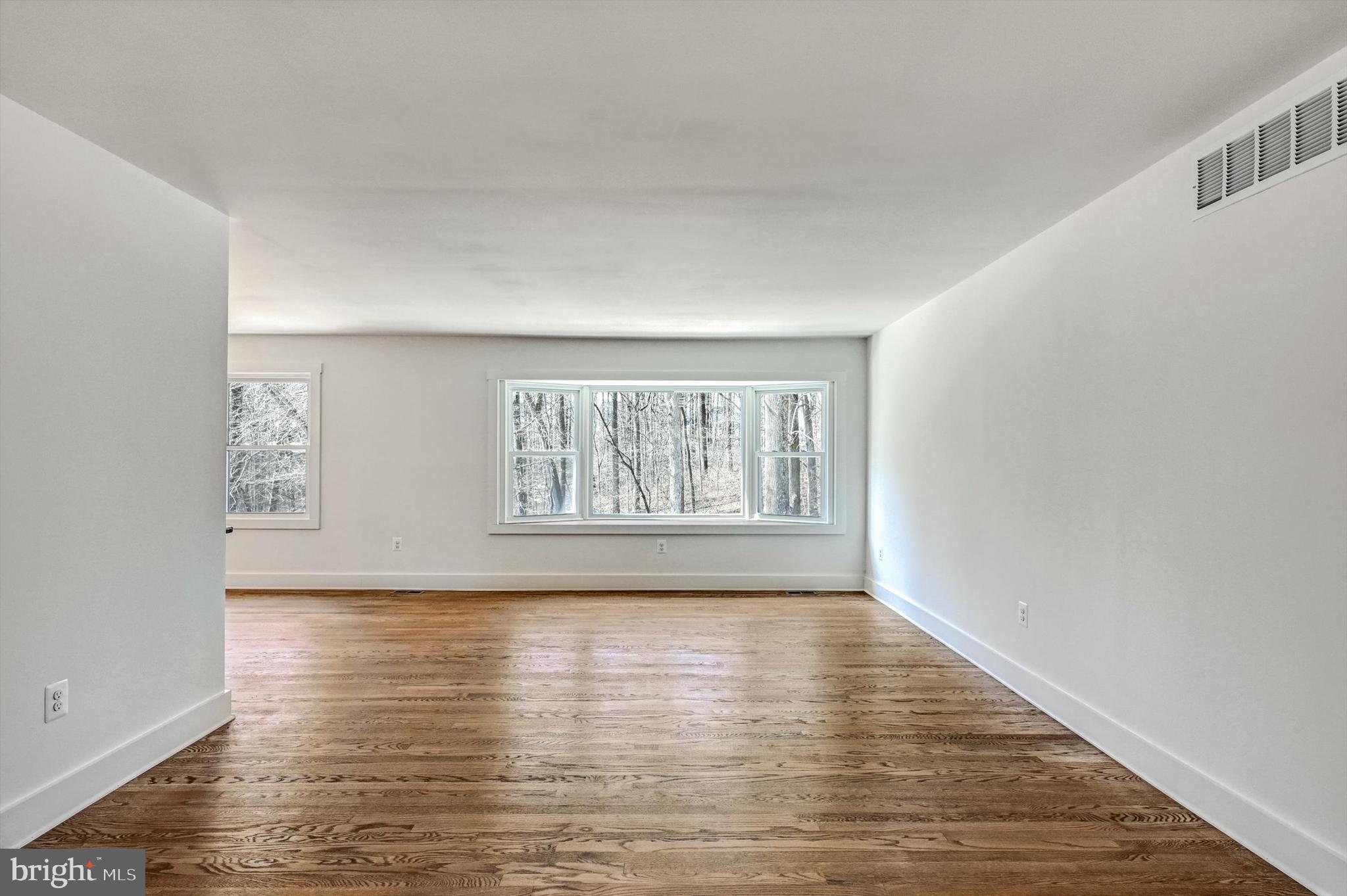 2806 Foxhound Road Ellicott City, MD 21042 - Photo 18 of 55 a view of an empty room with wooden floor and a window
