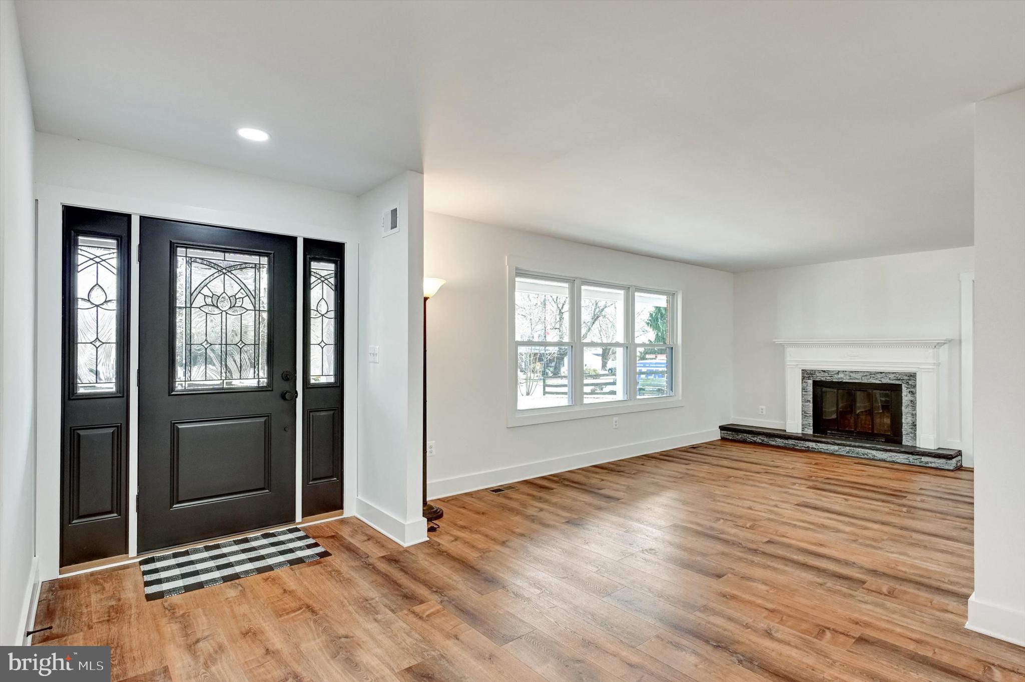 2806 Foxhound Road Ellicott City, MD 21042 - Photo 2 of 55 a view of an empty room with wooden floor and a window