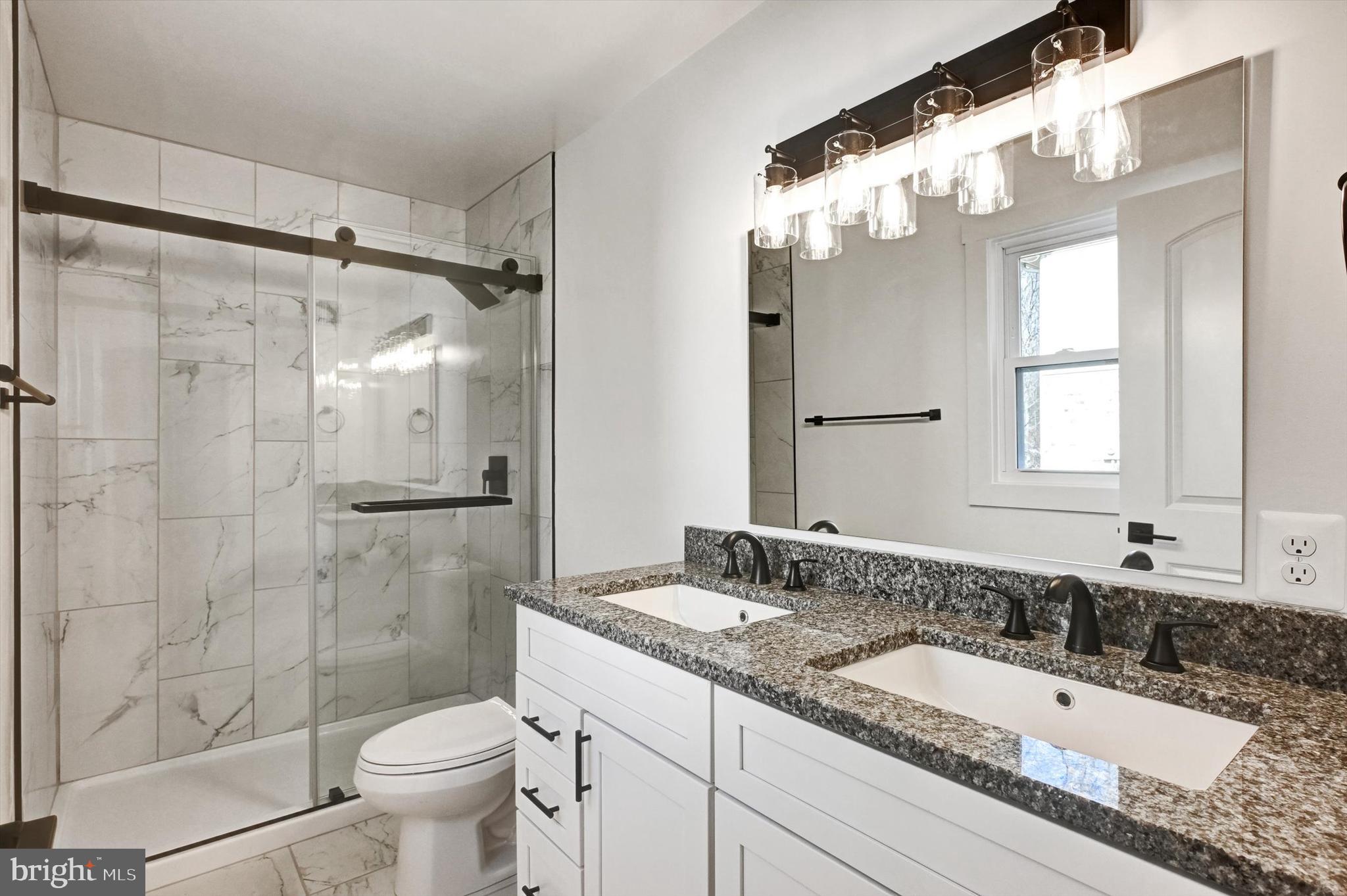 2806 Foxhound Road Ellicott City, MD 21042 - Photo 23 of 55 a bathroom with a granite countertop sink toilet and shower