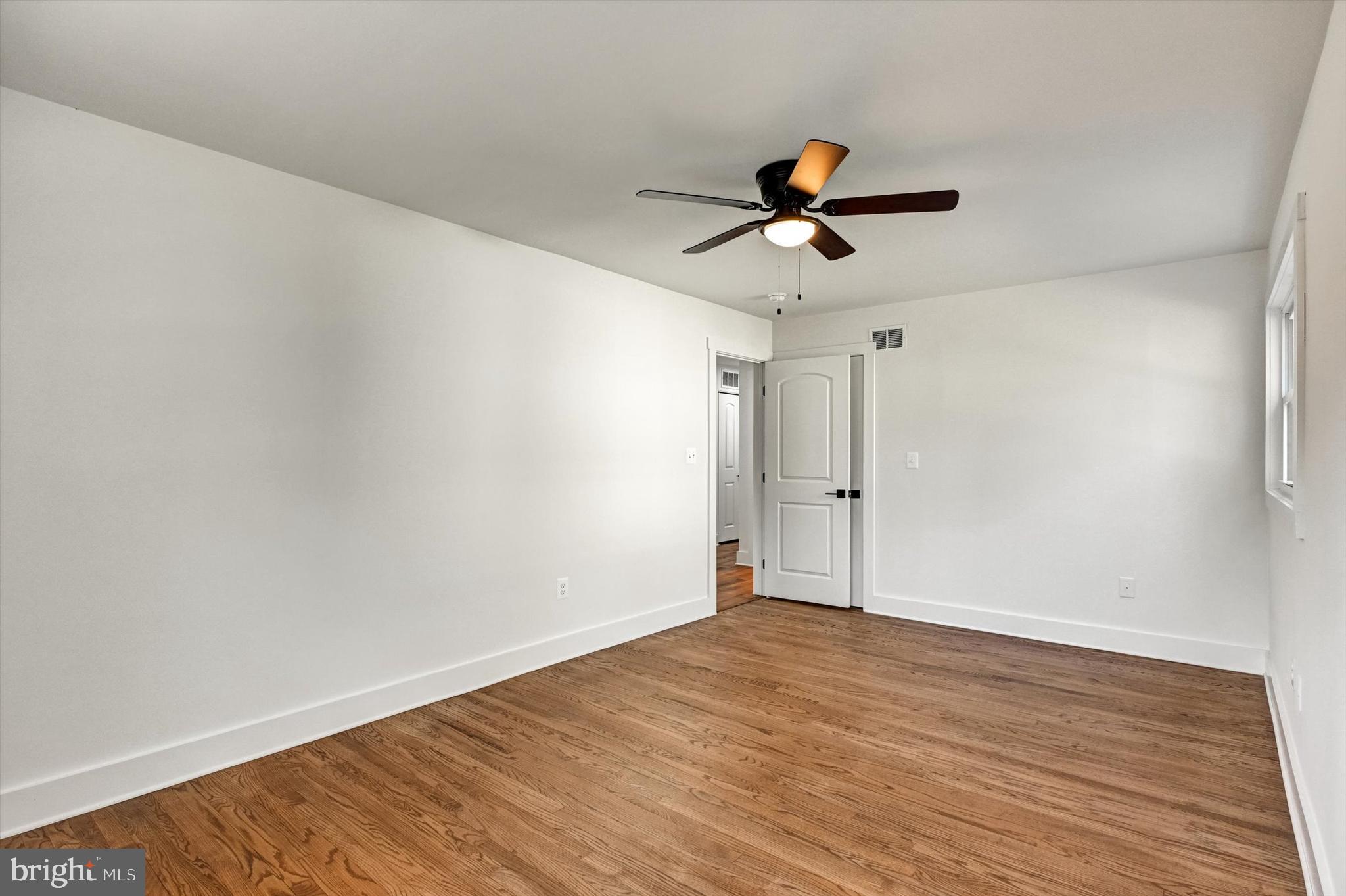 2806 Foxhound Road Ellicott City, MD 21042 - Photo 25 of 55 a view of a room with wooden floor and ceiling fan