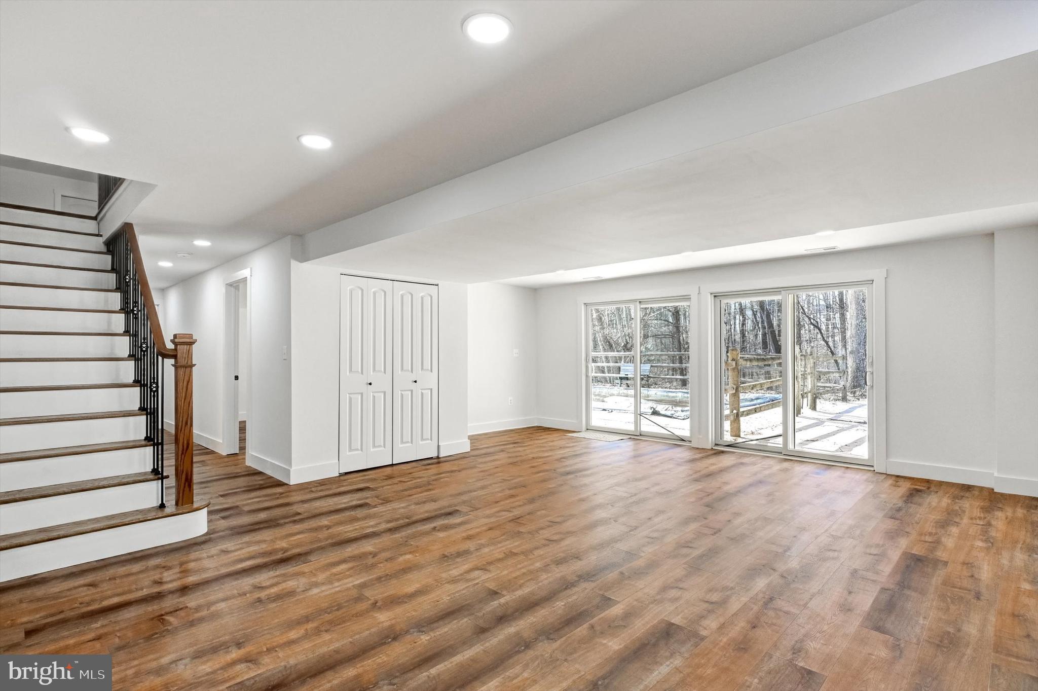 2806 Foxhound Road Ellicott City, MD 21042 - Photo 28 of 55 a view of an empty room with wooden floor and a window