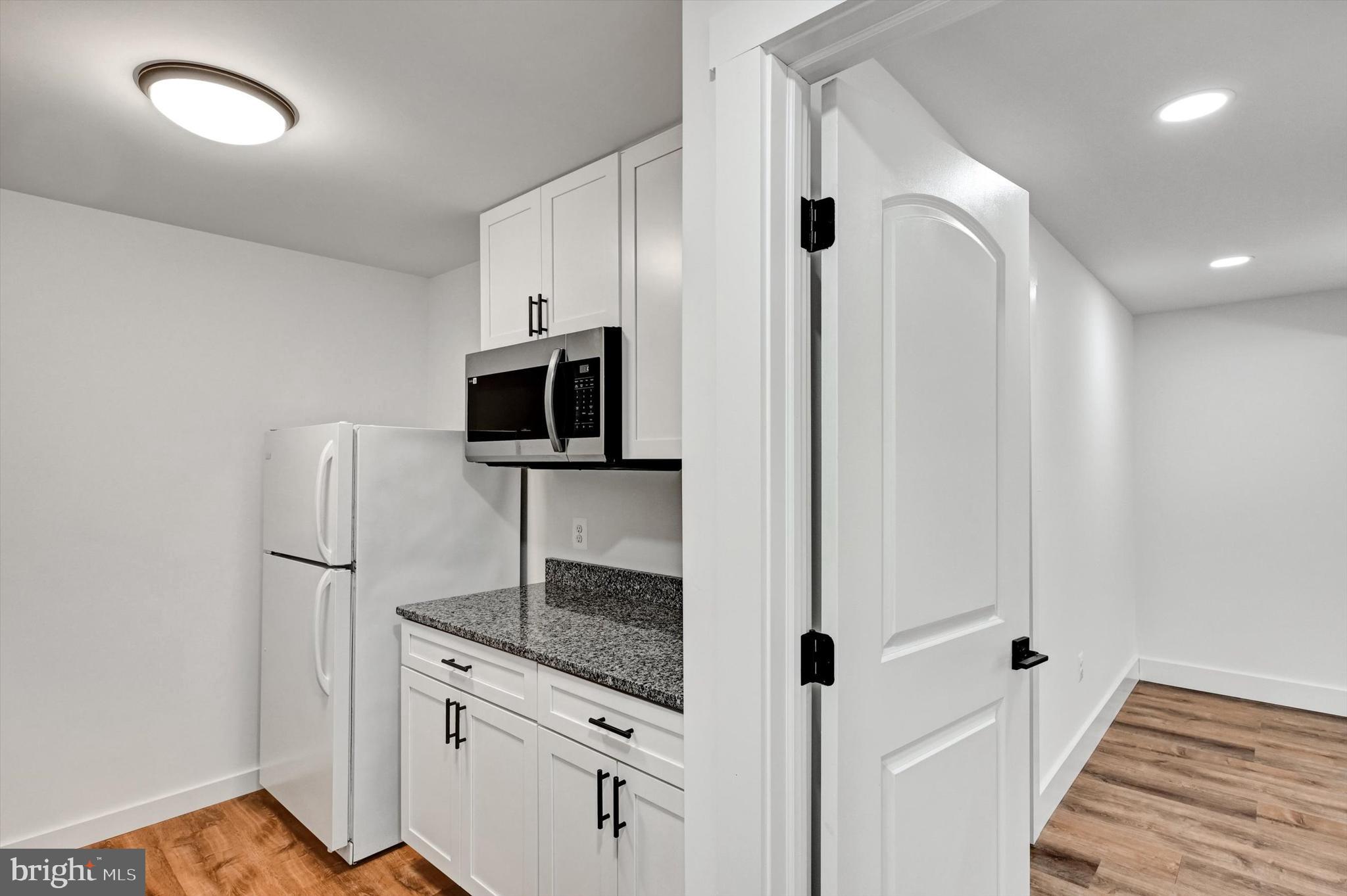 2806 Foxhound Road Ellicott City, MD 21042 - Photo 30 of 55 a kitchen with stainless steel appliances granite countertop a refrigerator and a sink