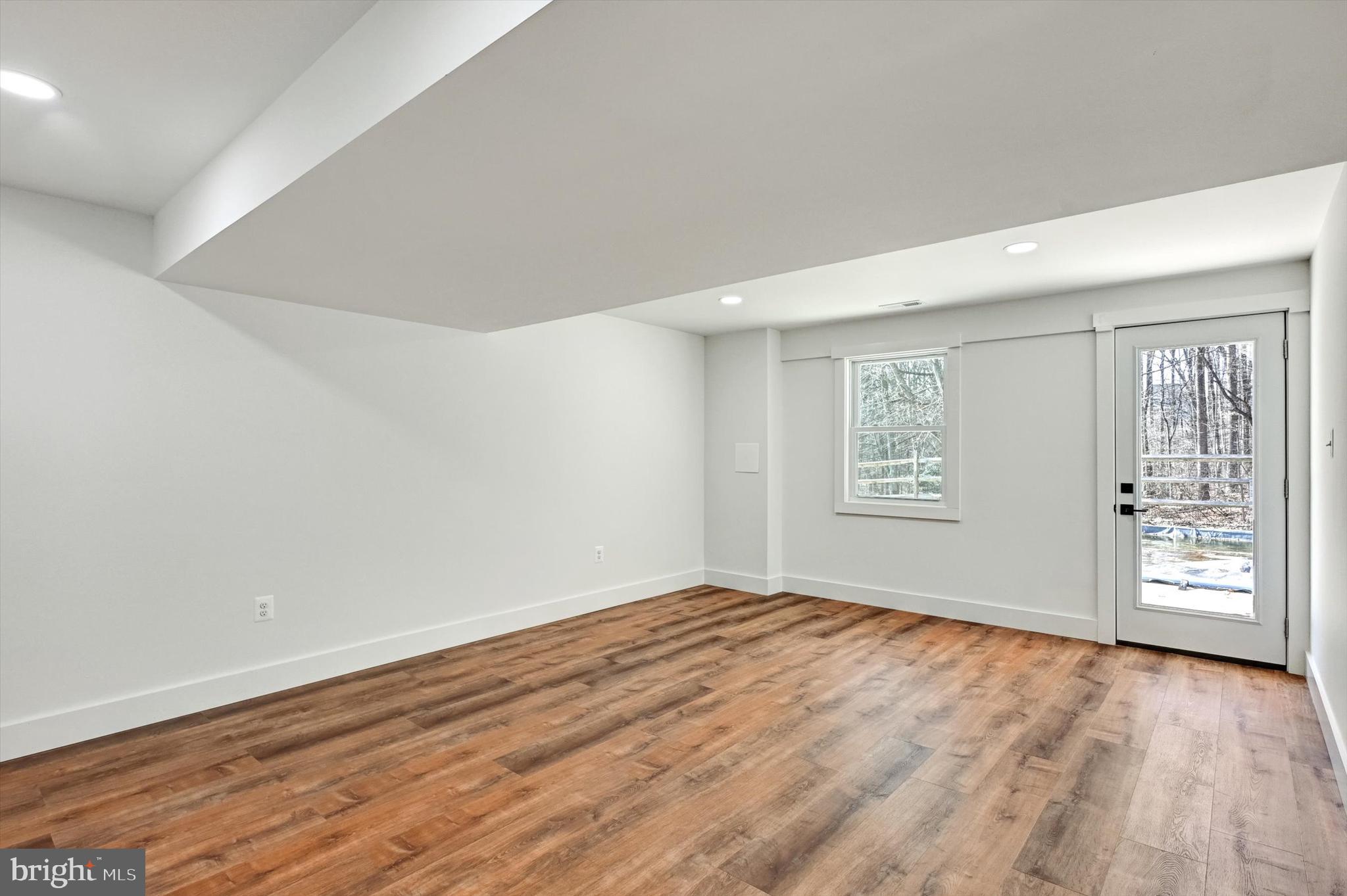 2806 Foxhound Road Ellicott City, MD 21042 - Photo 33 of 55 wooden floor in an empty room with a window
