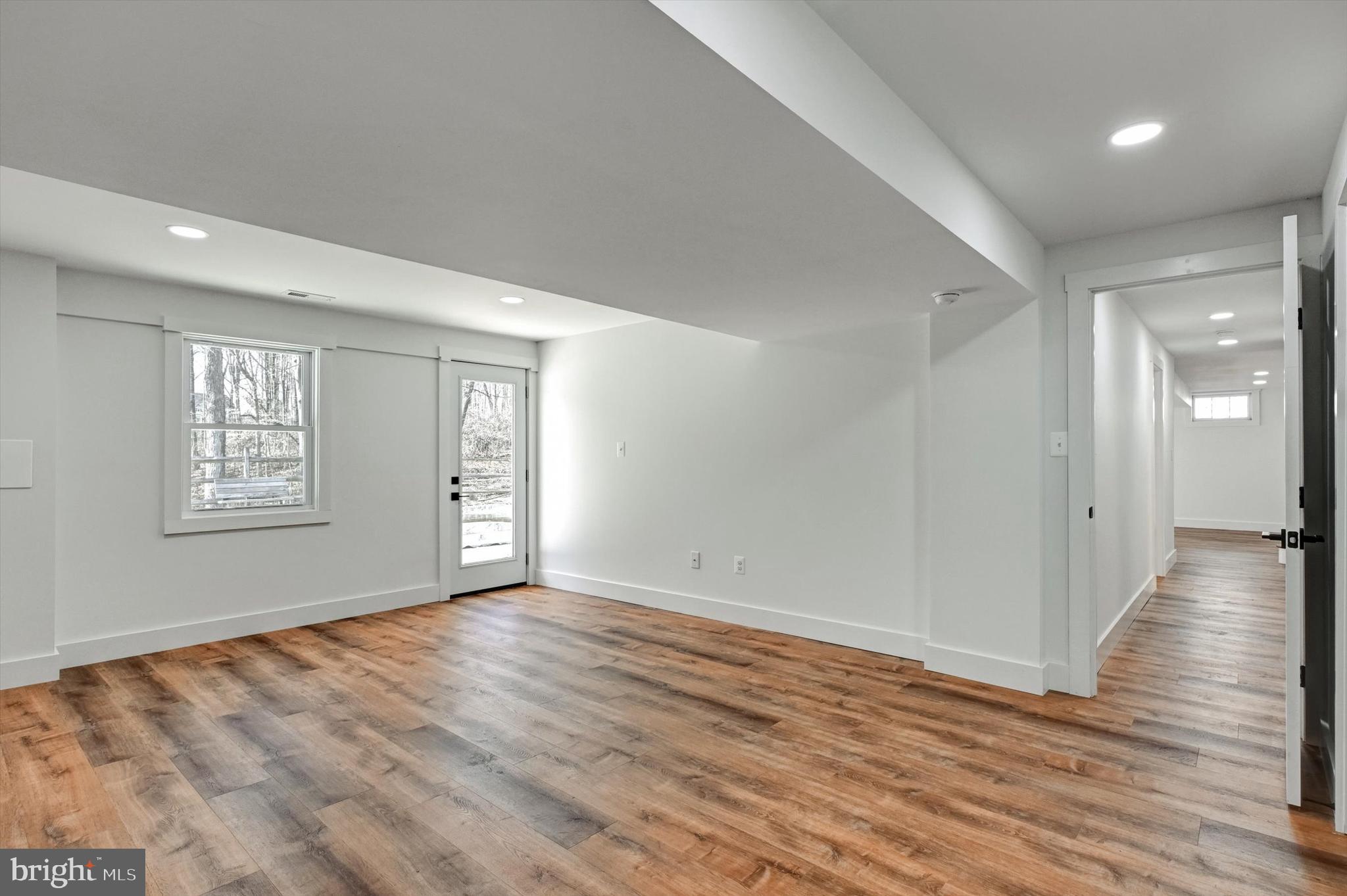 2806 Foxhound Road Ellicott City, MD 21042 - Photo 34 of 55 a view of an empty room with wooden floor and a window