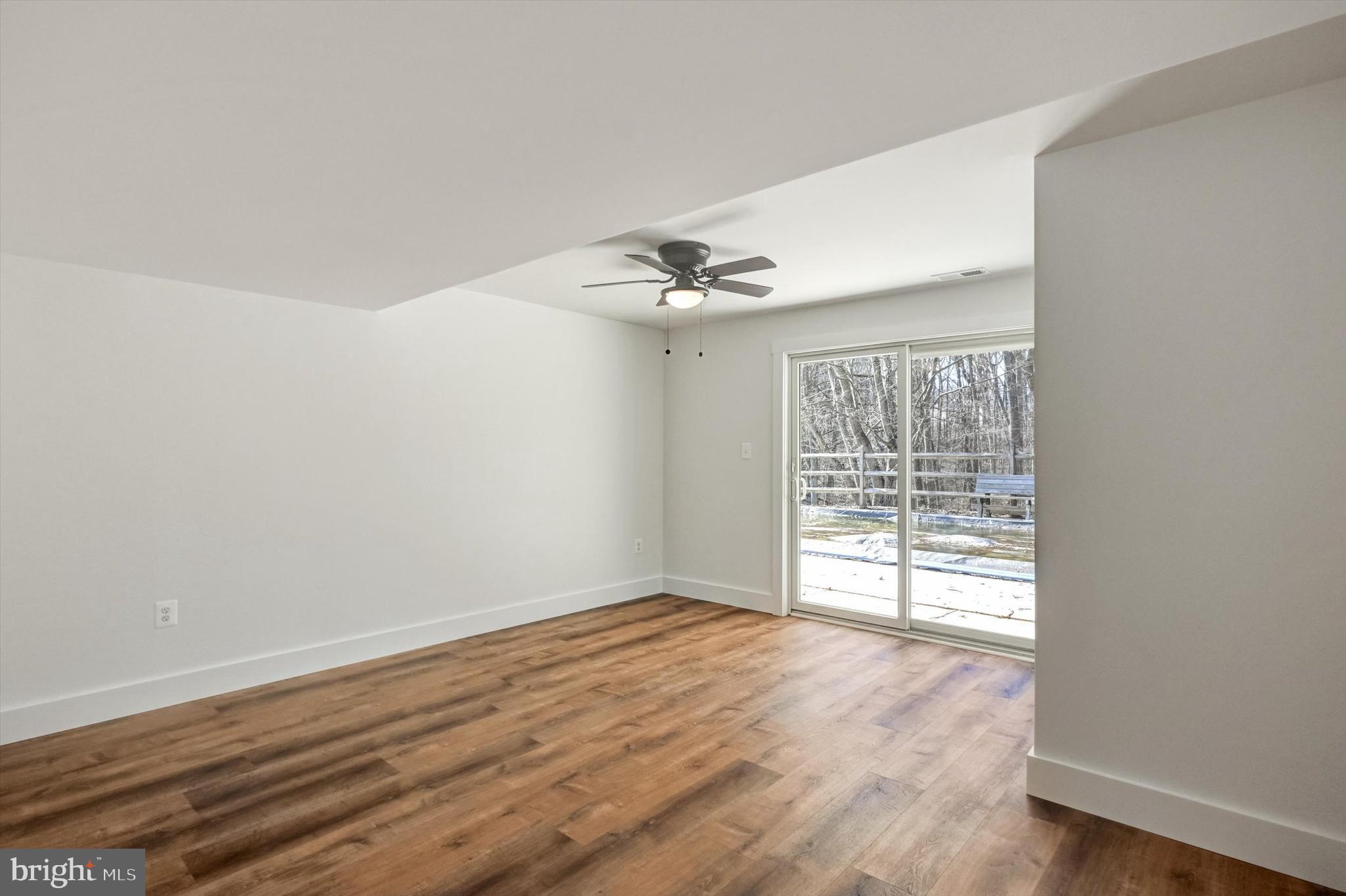 2806 Foxhound Road Ellicott City, MD 21042 - Photo 36 of 55 wooden floor in an empty room with a window