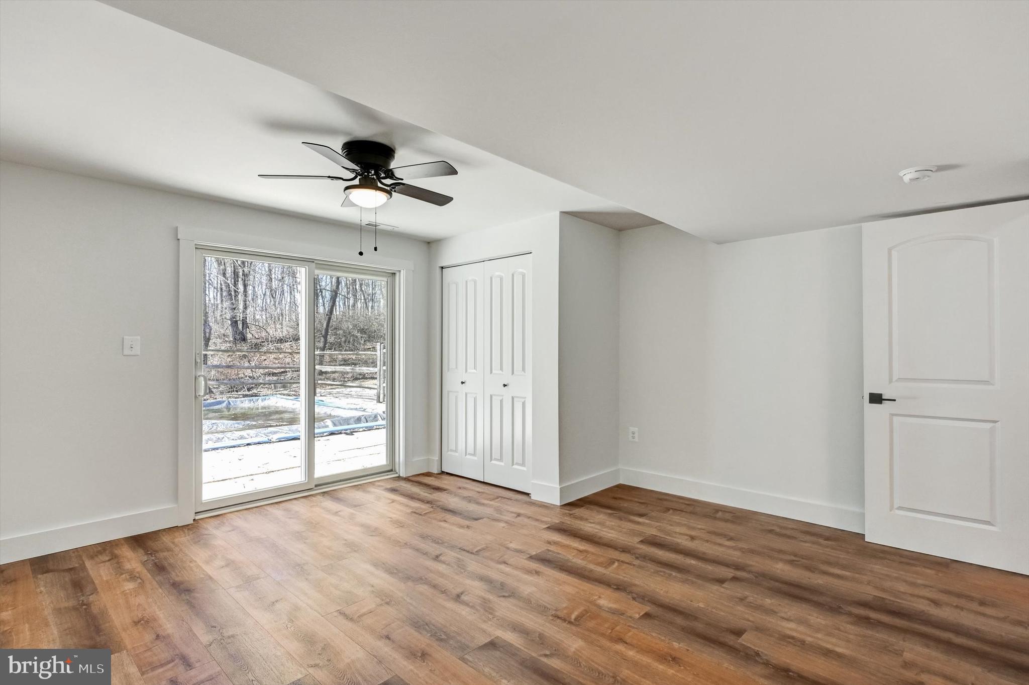 2806 Foxhound Road Ellicott City, MD 21042 - Photo 37 of 55 a view of an empty room with a window and wooden floor