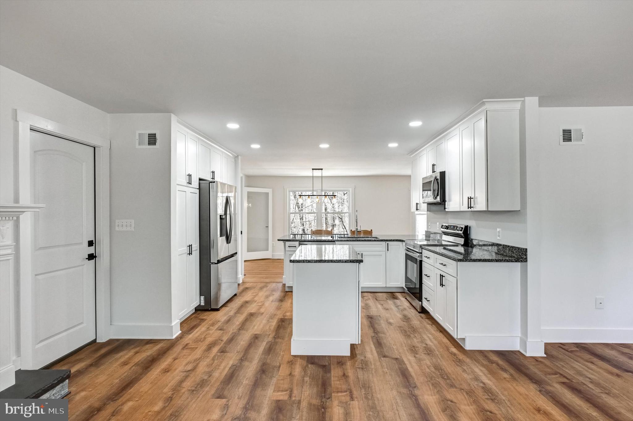 2806 Foxhound Road Ellicott City, MD 21042 - Photo 5 of 55 a large kitchen with cabinets wooden floor and stainless steel appliances