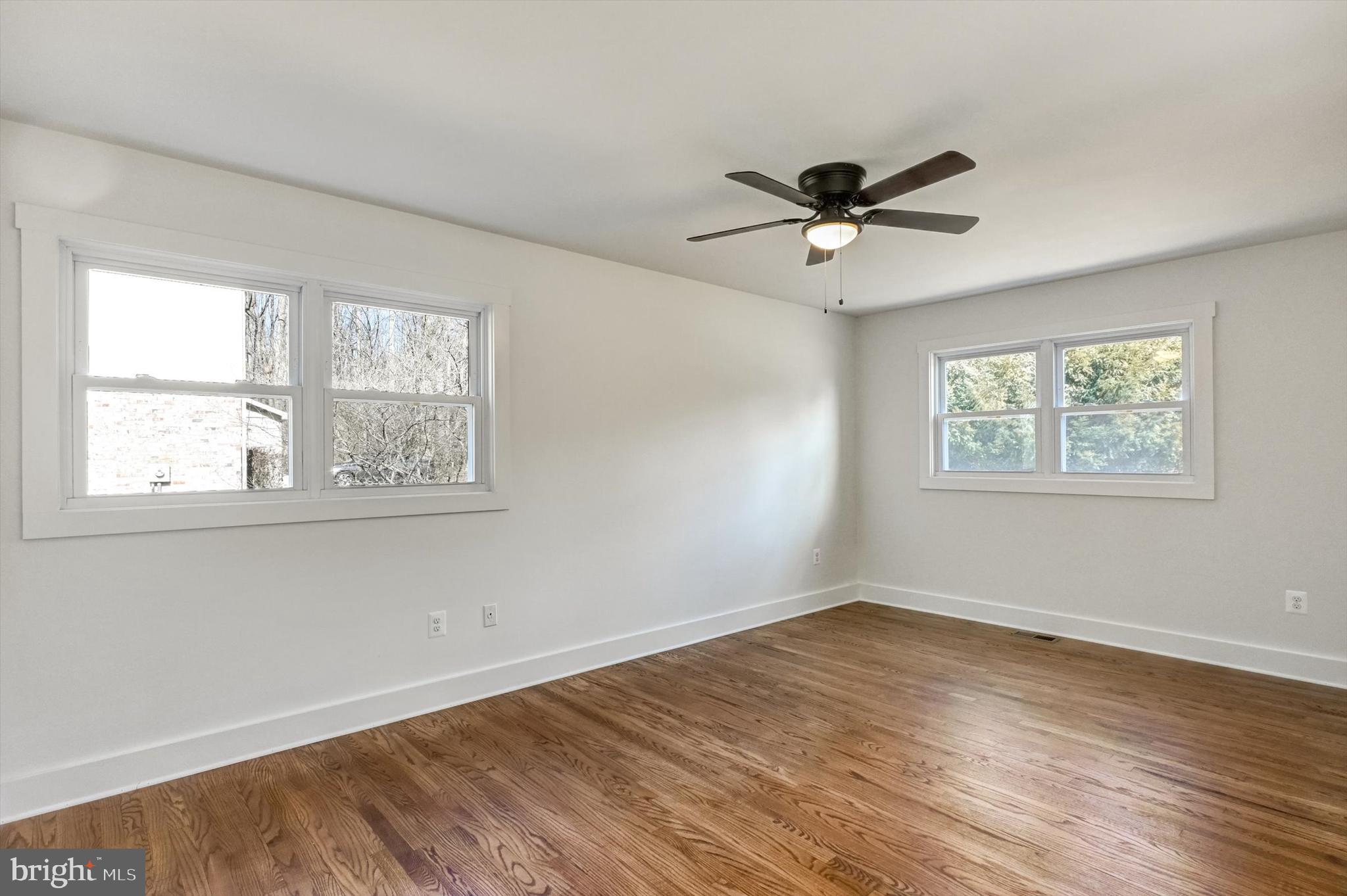 2806 Foxhound Road Ellicott City, MD 21042 - Photo 8 of 55 a view of a big room with wooden floor and windows