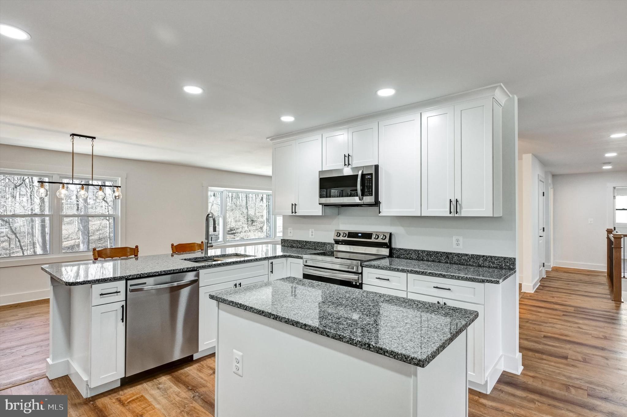 2806 Foxhound Road Ellicott City, MD 21042 - Photo 9 of 55 a kitchen with stainless steel appliances granite countertop a sink stove and cabinets