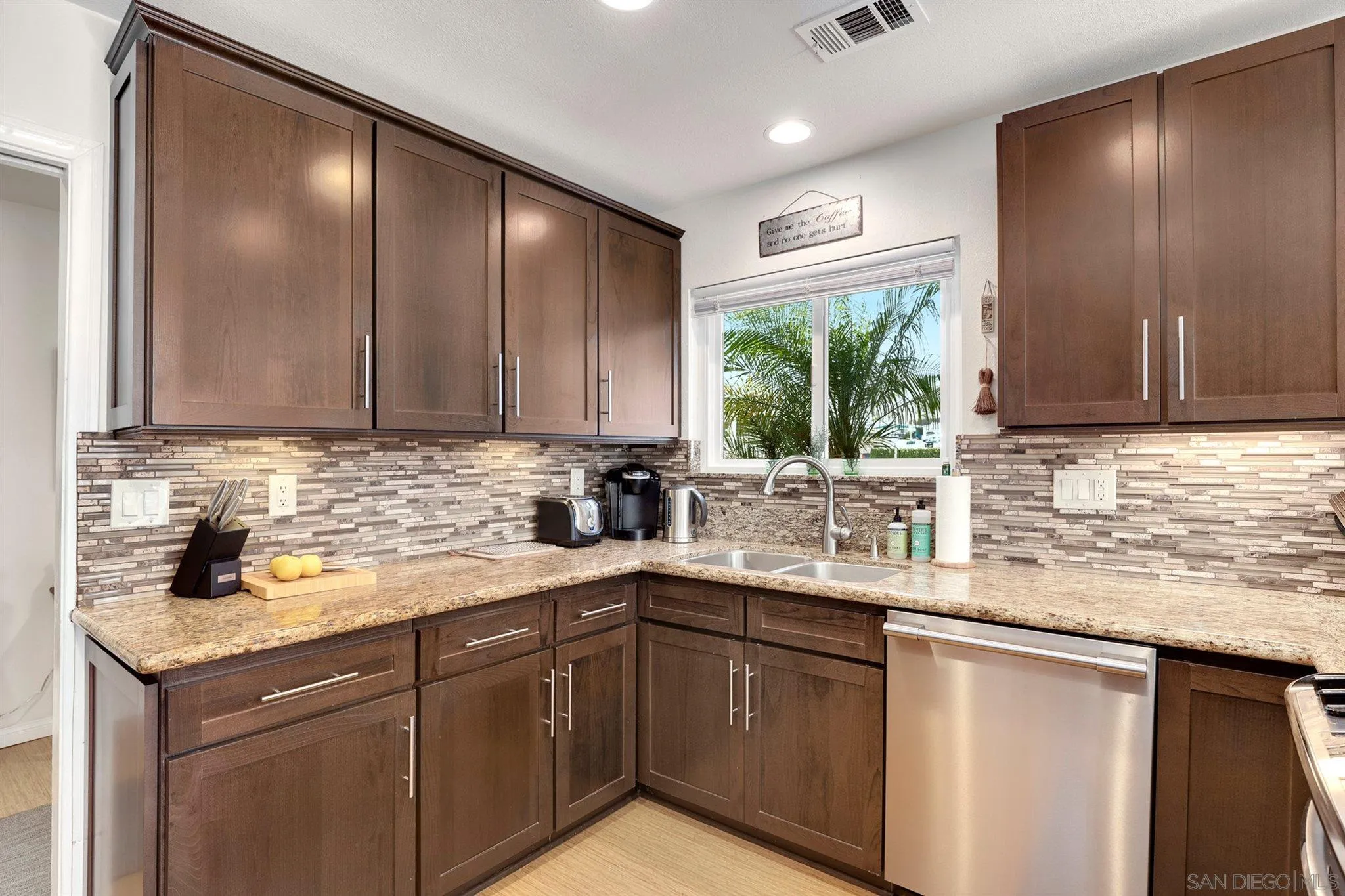 13716 Frame Road Poway, CA 92064 - Photo 11 of 34 a kitchen with stainless steel appliances granite countertop a sink and cabinets with wooden floor