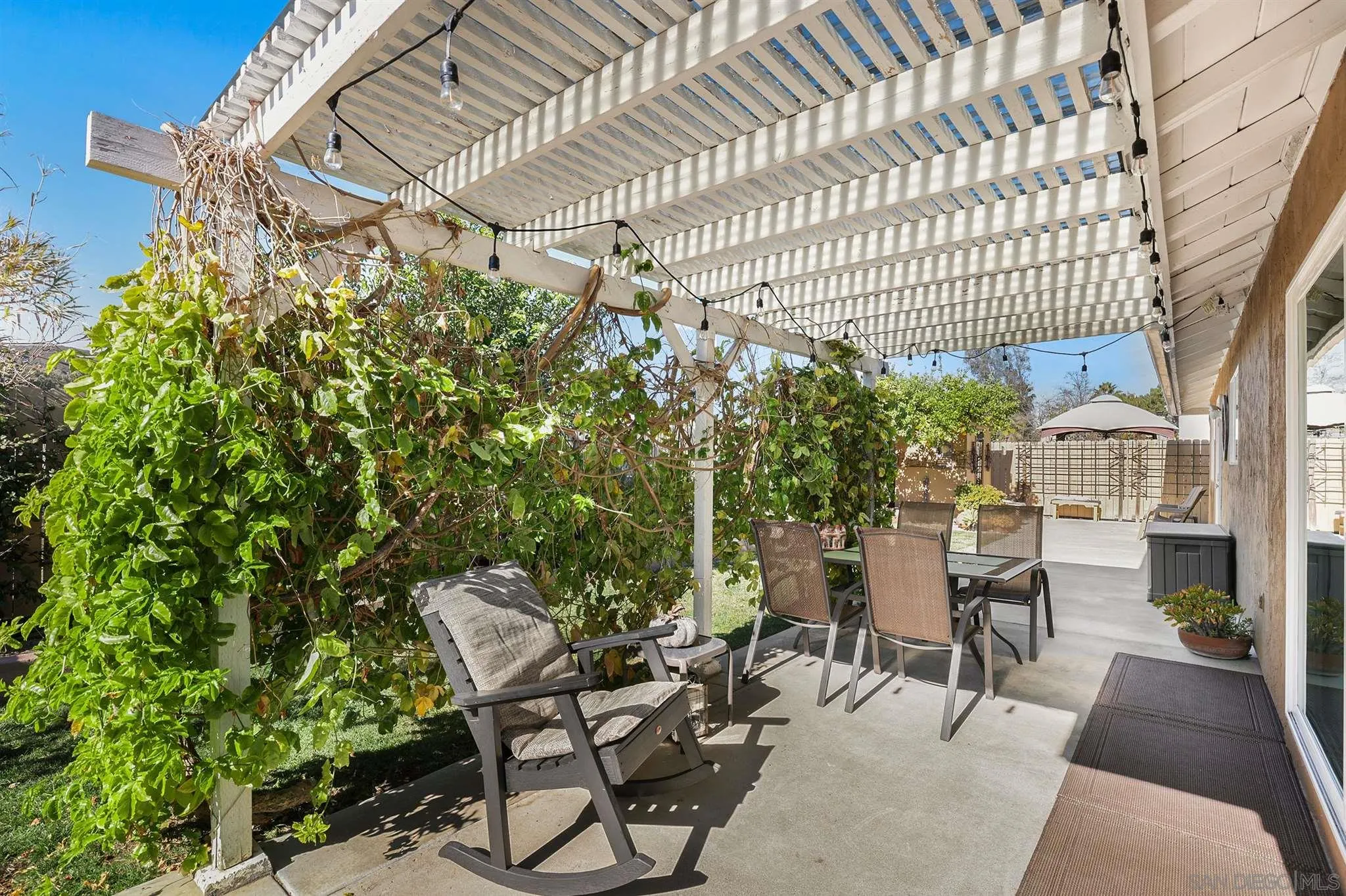 13716 Frame Road Poway, CA 92064 - Photo 24 of 34 a view of a patio with table and chairs and potted plants