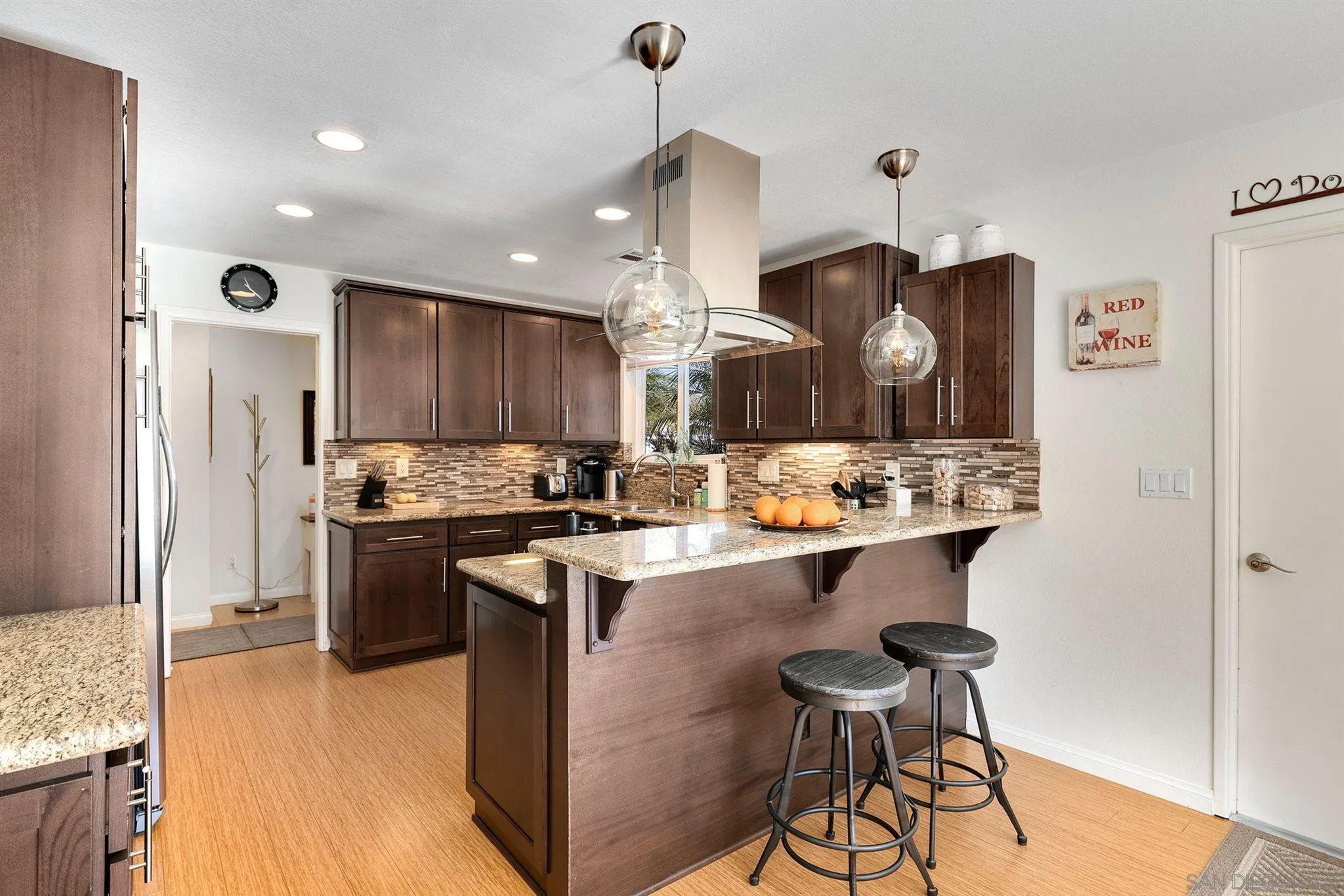 13716 Frame Road Poway, CA 92064 - Photo 8 of 34 a kitchen with stainless steel appliances kitchen island a sink and a refrigerator