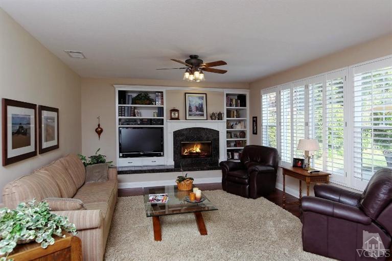 287 Knoll Ridge Road Simi Valley, CA 93065 - Photo 16 of 36 a living room with furniture flat screen tv and a fireplace