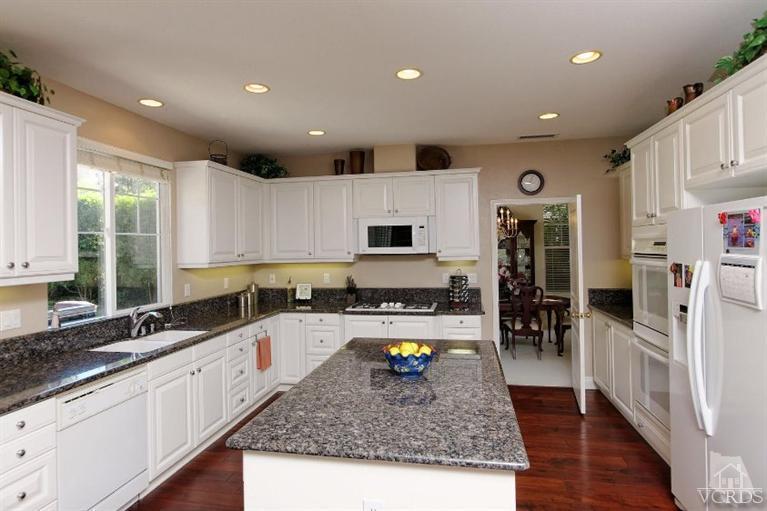 287 Knoll Ridge Road Simi Valley, CA 93065 - Photo 18 of 36 a kitchen with stainless steel appliances granite countertop a sink stove and refrigerator